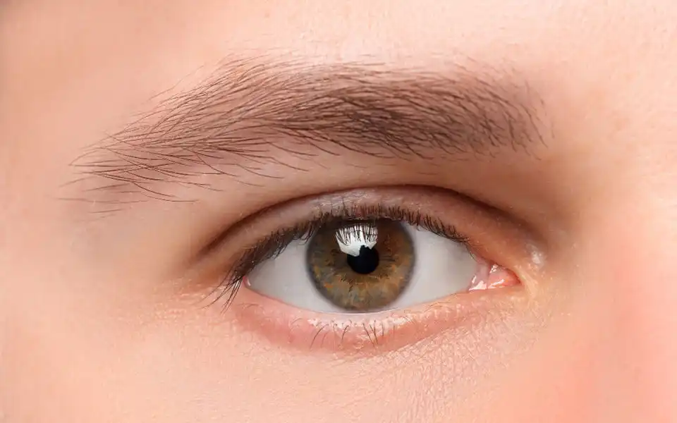 Person with prosthetic eye staring at the camera